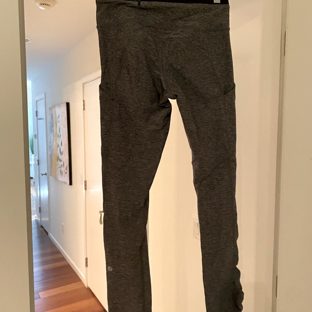Grey LuluLemon leggings with rouching on the side. Zipper pockets in the back.